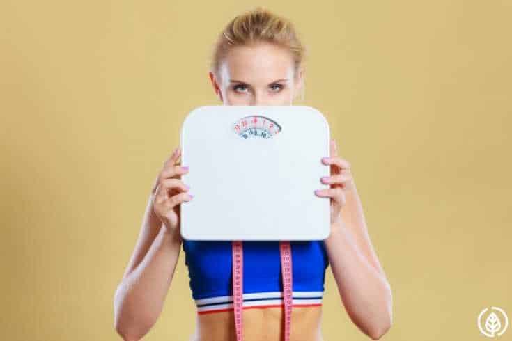 Woman holding scale 